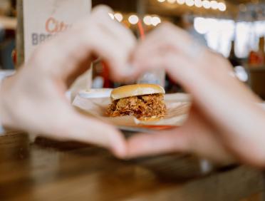 heart hands around a BBQ sandwich