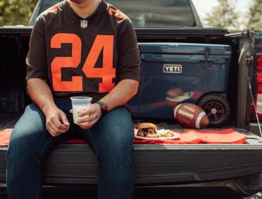 Sitting on a truck tailgate with a City Barbeque meal